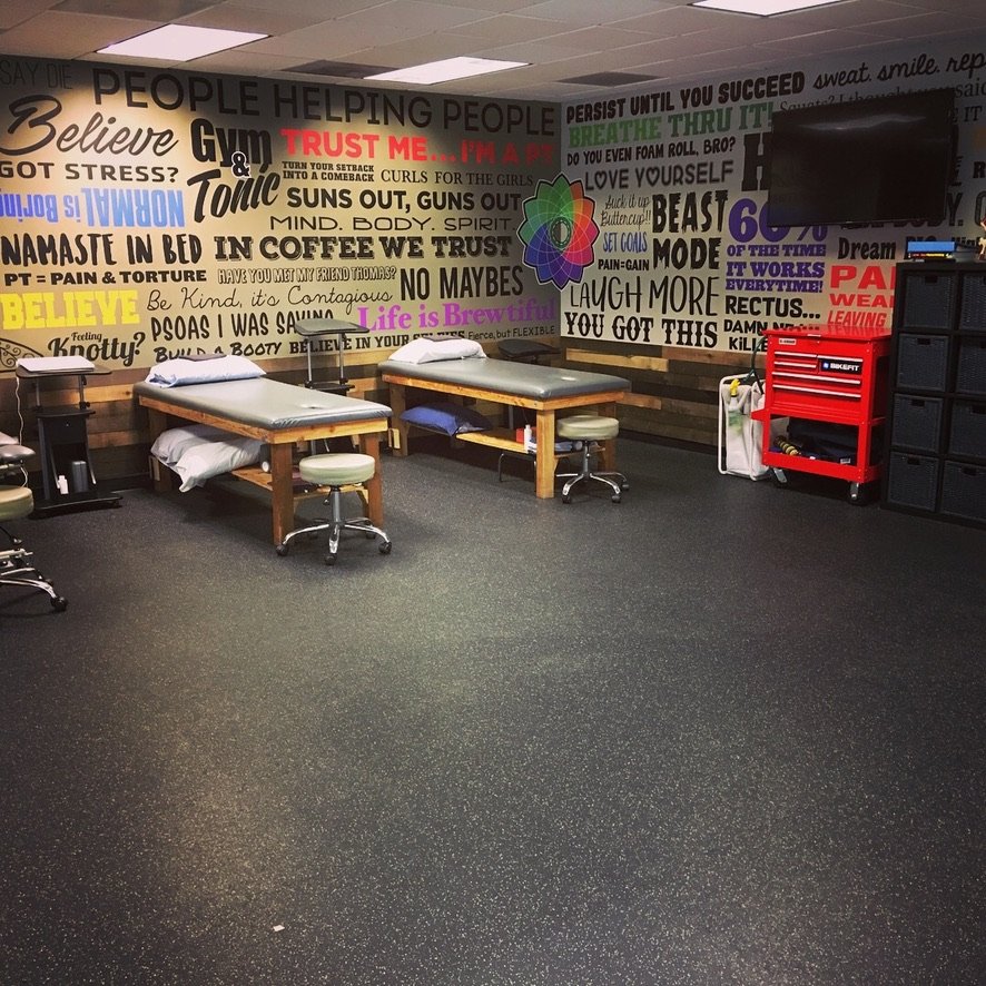 Catalyst Physical Therapy Mission Valley clinic interior — treatment rooms with reclaimed wood walls and motivational mural